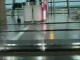 This guy finds the easy way to clean the glass along a moving escalator