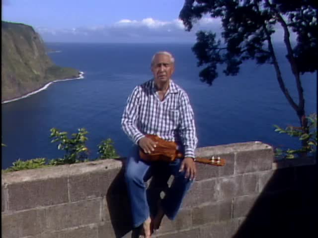 Interview with Eddie Kamae sitting on a wall at Waipiʻo Valley lookout; 1987